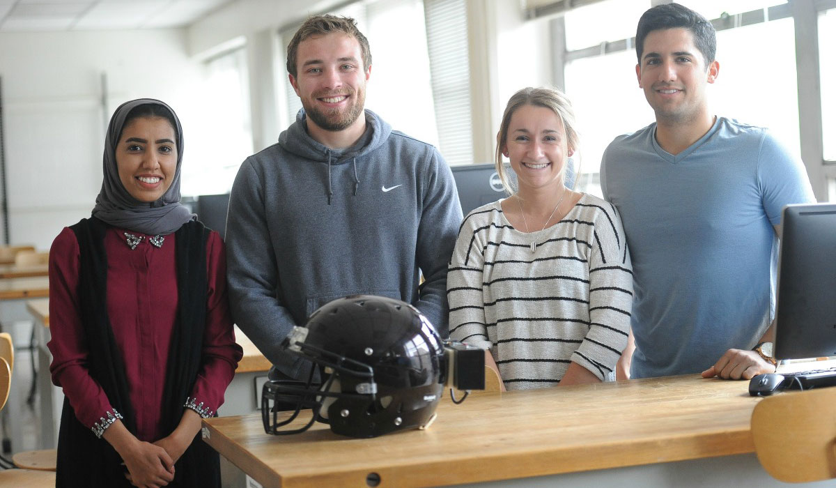 Students with a football helmet