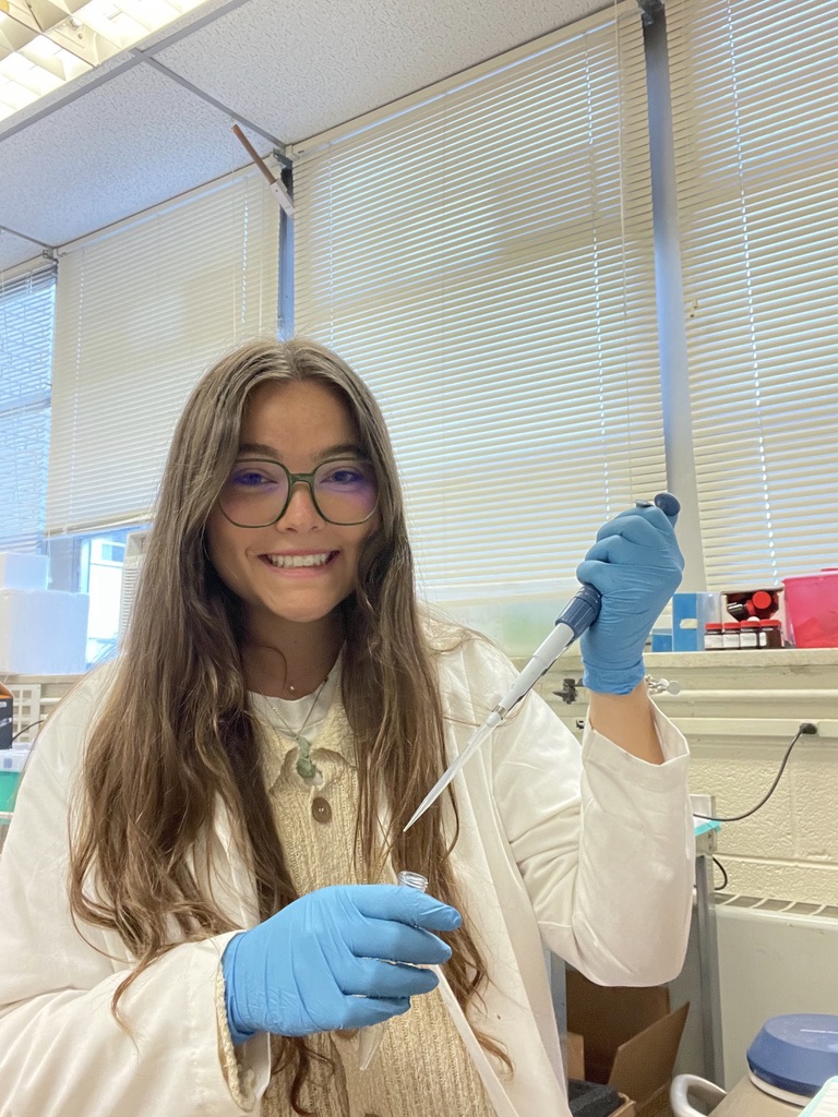 Elizabeth Staten holds a pipette while she works in the lab for her summer internship